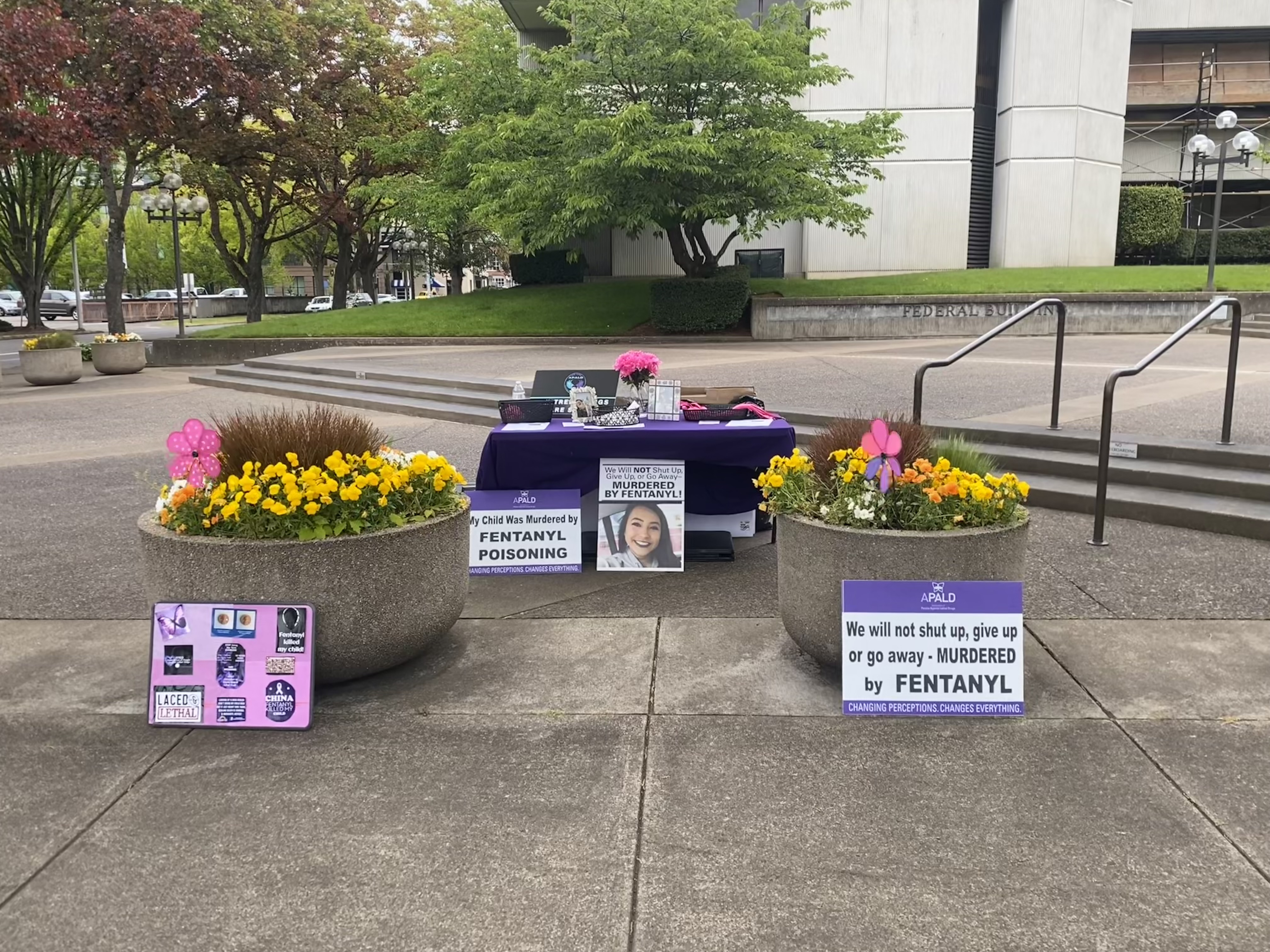 Image of Our 2024 rally table with lanyards wristbands and Narcan